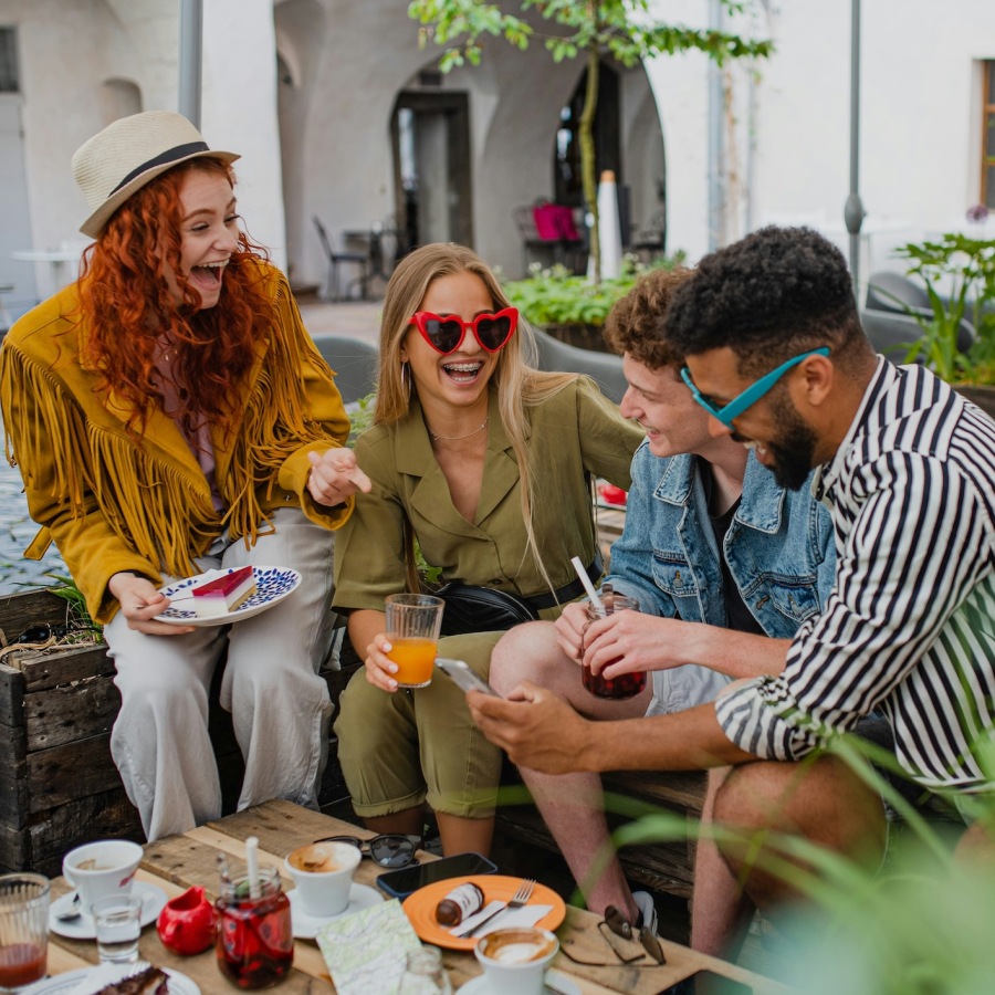 a group laughing and eating outside