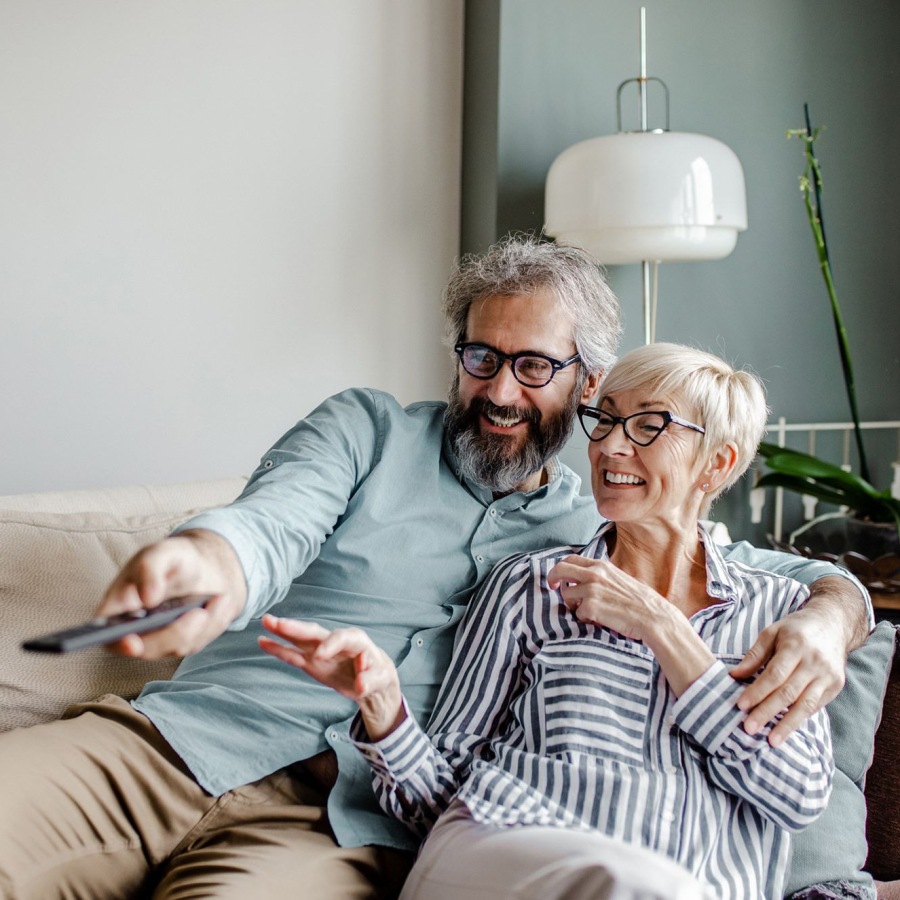 a couple on a couch watching TV